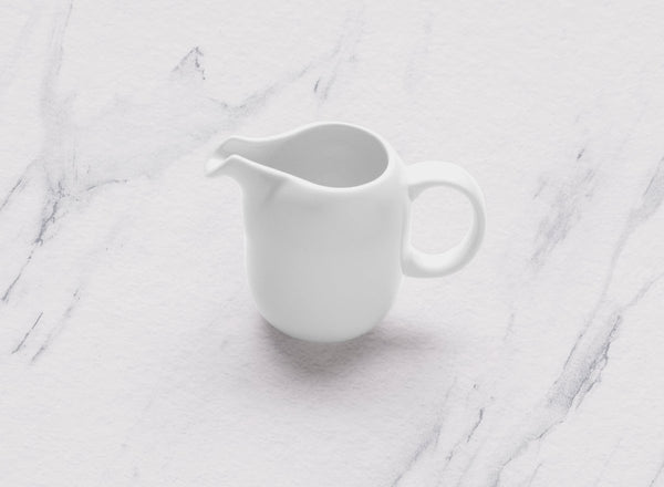 Ariane 5 Oz Vital Coupe - Warm White Porcelain Coupe Creamer With Handle - 12/Case (AVCARN000064015) - iFoodservice Online