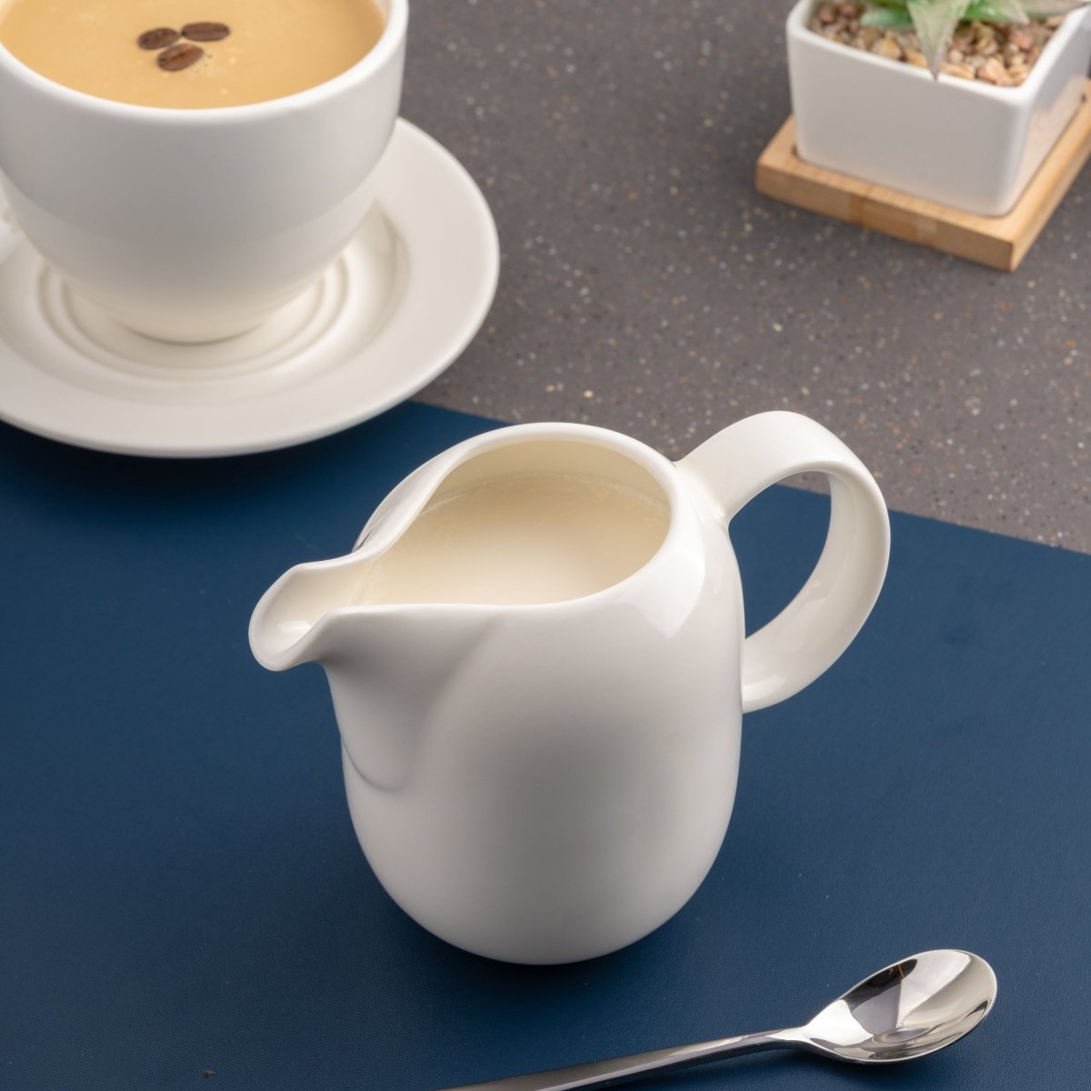 Ariane 8 4/9 Oz Vital Coupe - Warm White Porcelain Creamer With Handle - 6/Case (AVCARN000064025) - iFoodservice Online