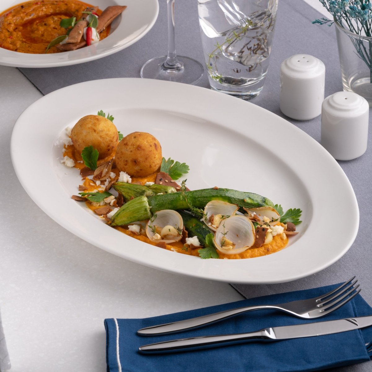 Ariane Prime 12 3/5'' x 8 2/3'' Prime - Warm White Porcelain Oval Platter - 6/Case (APRARN000015032) - iFoodservice Online