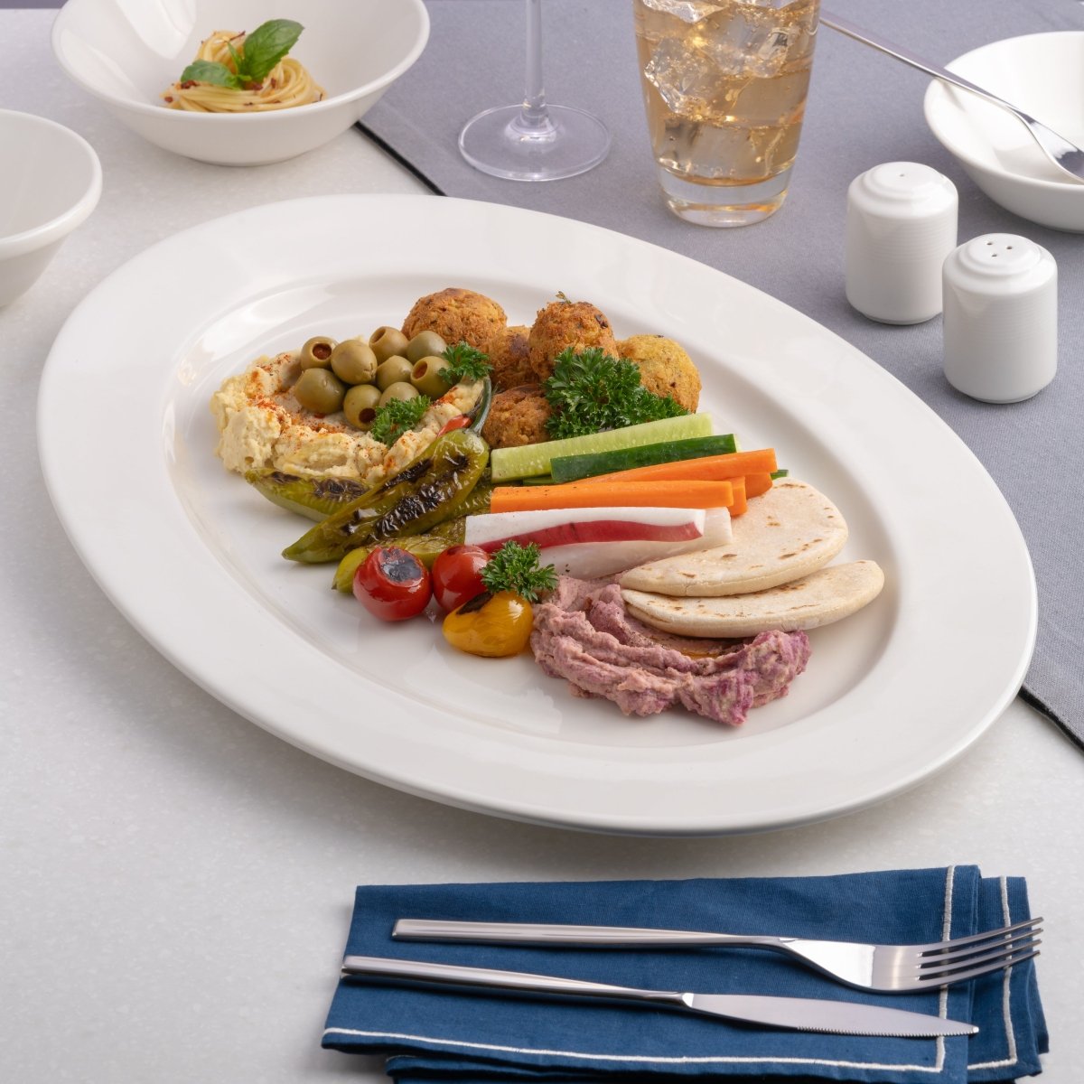 Ariane Prime 15'' x 10 3/7'' Prime - Warm White Porcelain Oval Platter - 6/Case (APRARN000015038) - iFoodservice Online