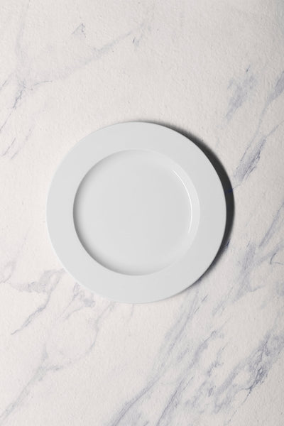 Ariane Prime 9" Prime - Warm White Porcelain Flat Plate - 12/Case (APRARN000011023) - iFoodservice Online