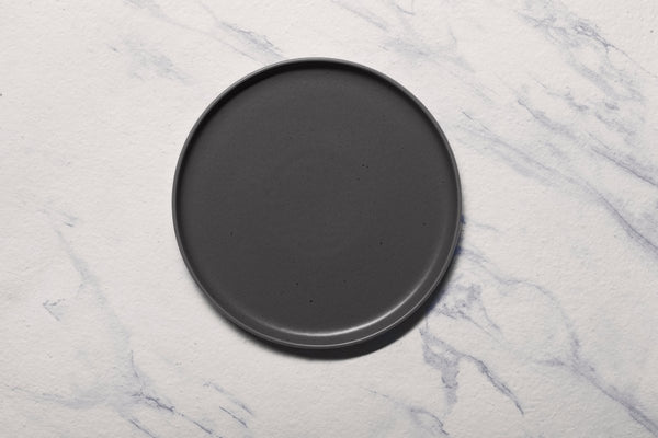 Ariane Selas 9 5/6" Selas - Charcoal Grey Dots Porcelain Short Rim Stackable Plate - 4/Case (ASEARNA05B11025) - iFoodservice Online