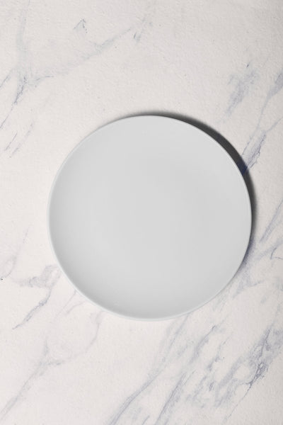 Ariane Vital Coupe 10 5/8" Vital Coupe - Warm White Porcelain Coupe Round Rimless Plate - 6/Case (AVCARN000011027) - iFoodservice Online