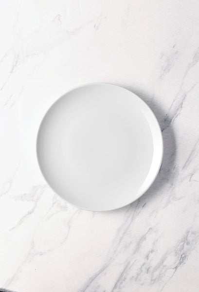 Ariane Vital Coupe 10" Vital Coupe - Warm White Porcelain Coupe Round Rimless Plate - 6/Case (AVCARN000011025) - iFoodservice Online