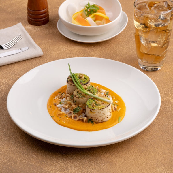 Ariane Vital Coupe 11 3/7" Vital Coupe - Warm White Porcelain Coupe Round Rimless Plate - 6/Case (AVCARN000011029) - iFoodservice Online