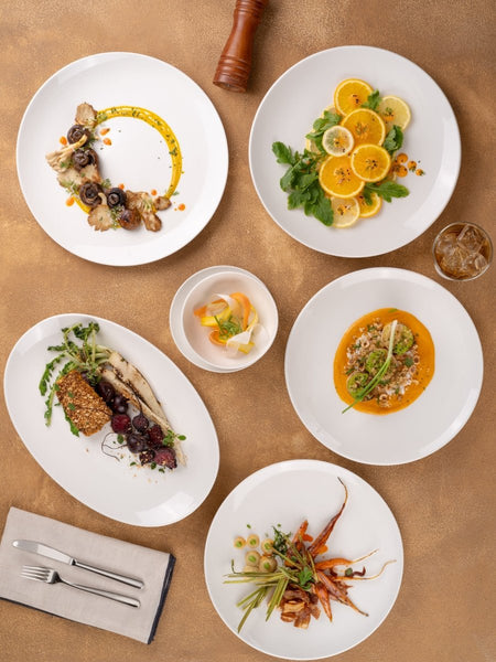 Ariane Vital Coupe 11 3/7" Vital Coupe - Warm White Porcelain Coupe Round Rimless Plate - 6/Case (AVCARN000011029) - iFoodservice Online