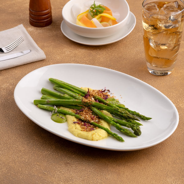 Ariane Vital Coupe 12 3/5" Vital Coupe - Warm White Porcelain Coupe Oval Plate - 6/Case (AVCARN000015032) - iFoodservice Online