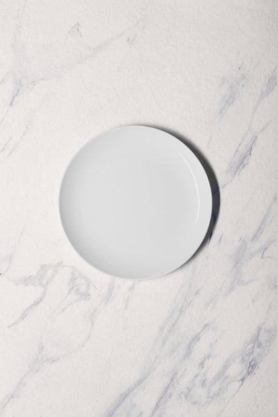 Ariane Vital Coupe 7" Vital Coupe - Warm White Porcelain Coupe Round Rimless Plate - 12/Case (AVCARN000011018) - iFoodservice Online