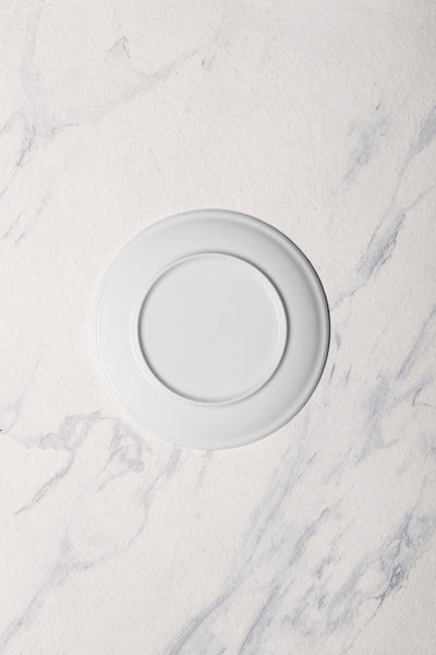Ariane Vital Coupe 7" Vital Coupe - Warm White Porcelain Coupe Round Rimless Plate - 12/Case (AVCARN000011018) - iFoodservice Online