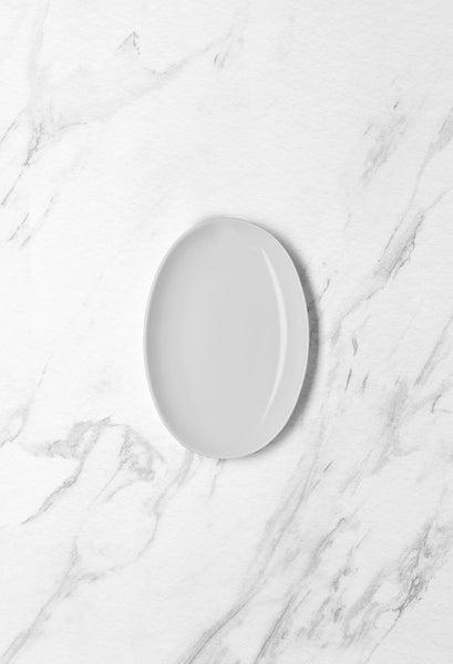 Ariane Vital Coupe 8 1/4" Vital Coupe - Warm White Porcelain Coupe Oval Plate - 12/Case (AVCARN000015021) - iFoodservice Online
