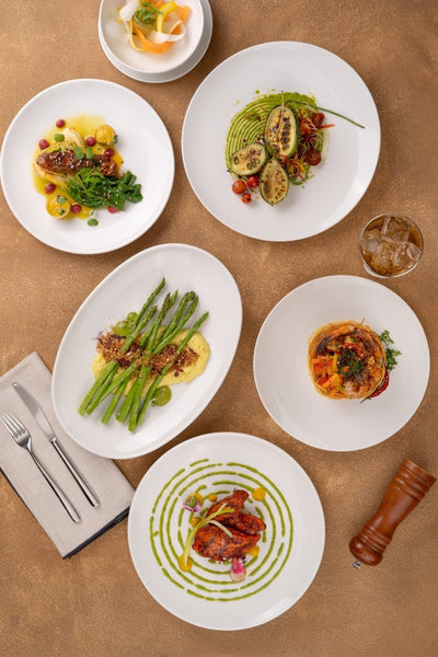 Ariane Vital Coupe 8 1/4" Vital Coupe - Warm White Porcelain Coupe Round Rimless Plate - 12/Case (AVCARN000011021) - iFoodservice Online