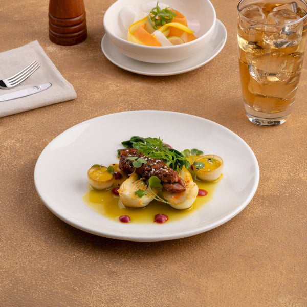 Ariane Vital Coupe 8 1/4" Vital Coupe - Warm White Porcelain Coupe Round Rimless Plate - 12/Case (AVCARN000011021) - iFoodservice Online