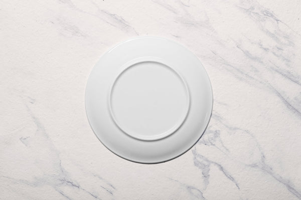 Ariane Vital Coupe 9 4/9" Vital Coupe - Warm White Porcelain Coupe Round Rimless Plate - 6/Case (AVCARN000011024) - iFoodservice Online