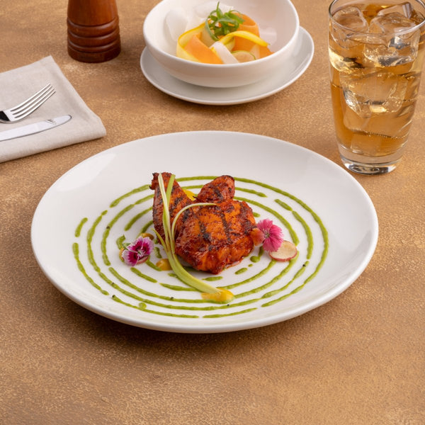 Ariane Vital Coupe 9 4/9" Vital Coupe - Warm White Porcelain Coupe Round Rimless Plate - 6/Case (AVCARN000011024) - iFoodservice Online