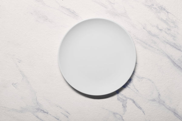 Ariane Vital Coupe 9 4/9" Vital Coupe - Warm White Porcelain Coupe Round Rimless Plate - 6/Case (AVCARN000011024) - iFoodservice Online